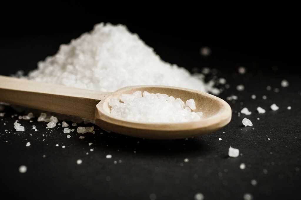 Picture of salt on spoon to represent the salt (or saline) used in the Neti Pot solution